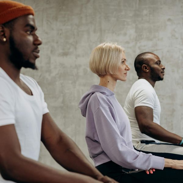 Diverse group of people of different ages and body types practicing yoga together.